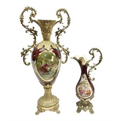 Twin handled vase, the ceramic urn form body decorated with floral sprigs and figural panel, the metal handles designed as vines, together with a similar ewer, vase H75cm 