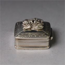 Modern silver pill box, of square form, the hinged cover surmounted with figure of a frog within a engraved scroll edge, hallmarked hallmarked Martin Gerald & Sid Adler, London 2000, W3cm