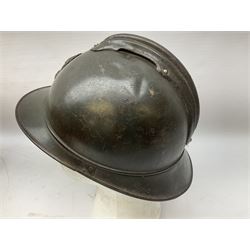 WW2 French M-26 Adrian Pattern Steel Helmet, original olive drab paint finish; flaming grenade badge to the front signifying issue to an Infantry regiment; original leather liner and leather chinstrap; and WW2 Dutch steel helmet with liner and chin strap (2)