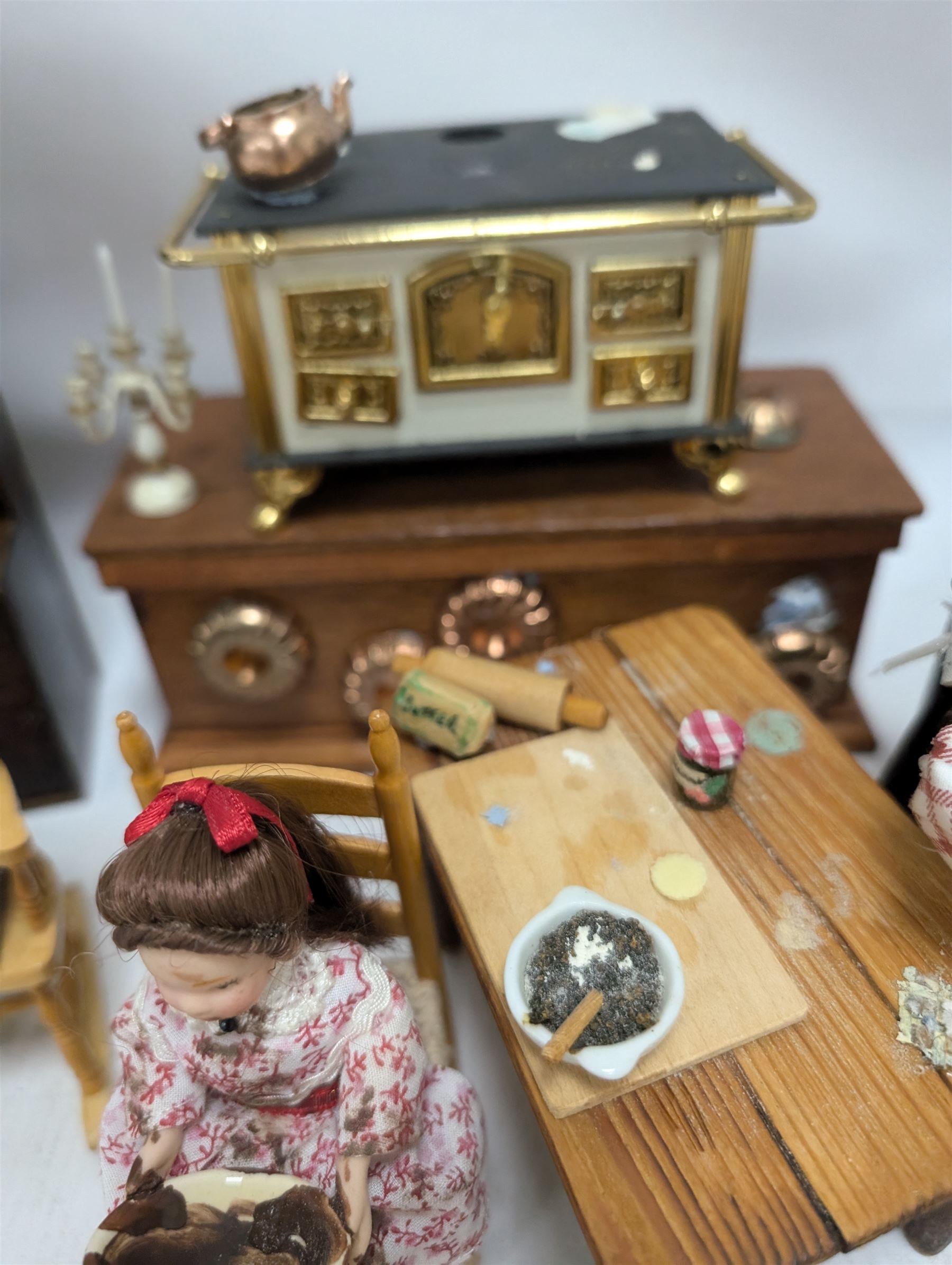 Victorian and later style dolls house kitchen furniture, including countertop, dresser displaying copper pots and blue and white ceramics, baking table, oven, three figures and a collection of food and baking accessories