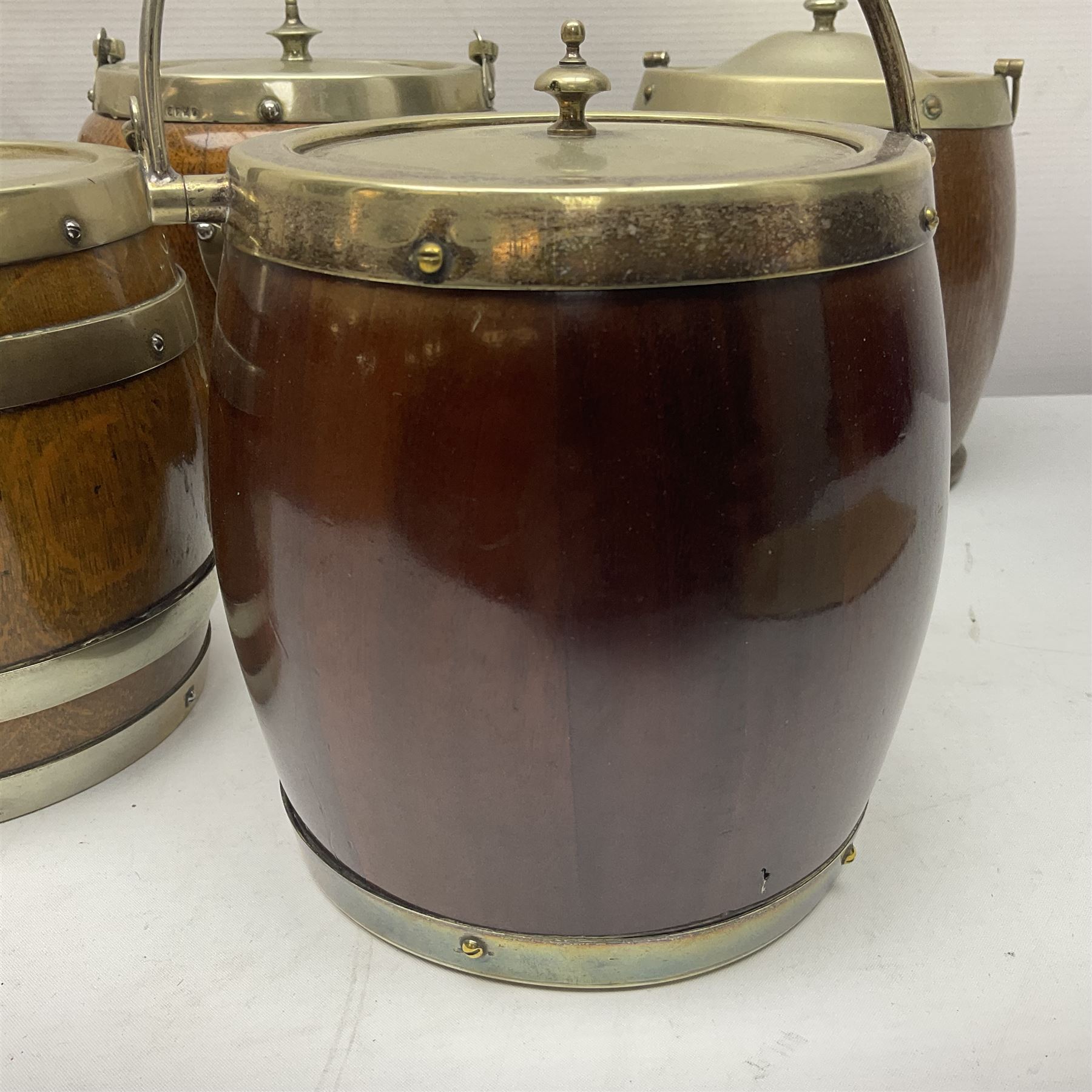 Five early 20th century biscuit barrels with silver-plated mounts, one made from Mahogany from HMS Hindustan