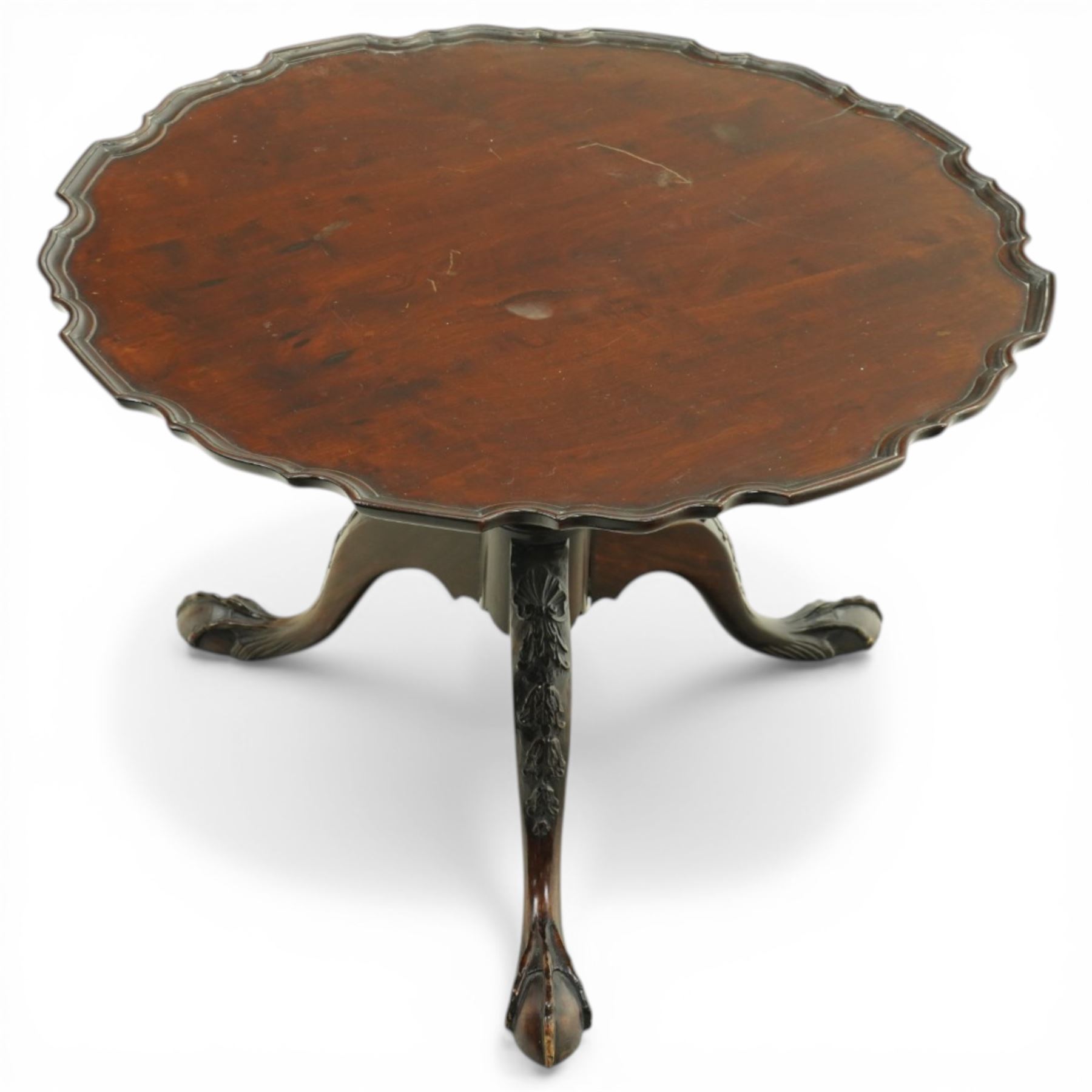 Late 19th century mahogany piecrust occasional table, circular top with scalloped moulded edge, on a turned pedestal with carved cabriole supports terminating in claw and ball feet
