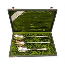 Set of three continental silver serving spoons/fork, stamped 800,  maker C F Gutig, Leipzig, within silk lined fitted case, together with an early 20th century silver mounted glass decanter, the body with fluted decoration and with glass flambe style stopper, with silver collar, hallmarks worn and indistinct, H35cm