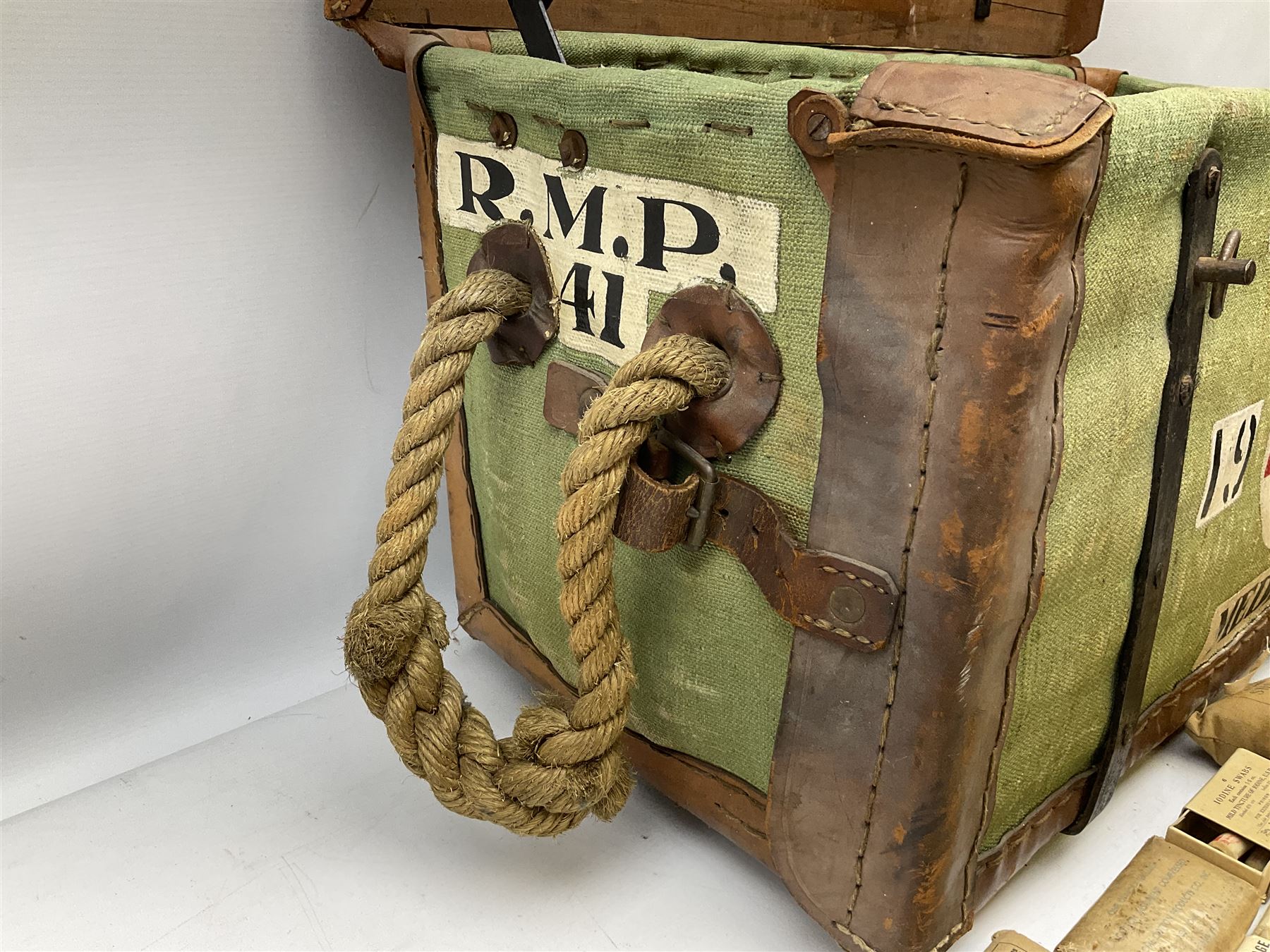 WW2 British Army RAMC 'Regimental Medical Pannier', well marked externally and dated 1941, stamped May 1943 internally, canvas covered wicker form with leather edges, hinged top and fall front with two rope carrying handles, fitted iron locking straps with securing chains; contains various unused field dressings and bandages with WW2 dates and two pillows; original label under lid L79cm
