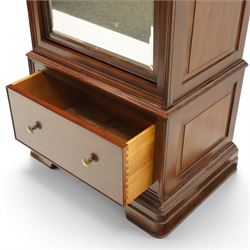 Willis & Gambier - hardwood swing mirrored door cabinet, in a dark cherrywood finish with moulded cornice over mirrored door incorporating adjustable cheval mirror action, enclosing a shelved interior, lower drawer with brass knob handles, panelled sides and stepped plinth base