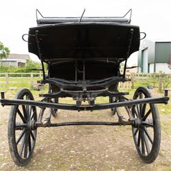 Town Coach by John Marstons Birmingham - Ex Film

A black painted five glass Town Coach by John Marston's Carriage Works Ltd, Birmingham, with enclosed glazed passenger compartment, curved front glass, external coachman's box seat and pole for driving with a pair of horses. The carriage has a timber coach body with buttoned black leather interior, blue upholstered seat cushions, plated exterior door handle, maker plates to the body and step, and John Marston marked hub caps. Mounted on black painted wooden spoked wheels with rubber tyres, leaf spring suspension, underbody turntable steering and iron fittings throughout.
Featured on the film set of 'Victoria' with Jenna Coleman

Features

• Black painted enclosed coach body
• Glazed passenger compartment with five windows
• Curved front glass
• Buttoned black leather interior
• Blue upholstered seat cushions
• External coachman's box seat
• Timber coach body
• Wooden spoked wheels
• Rubber tyres
• Leaf spring suspension
• Underbody turntable steering
• Pole for pair of horses
• Iron foot steps
• Plated exterior door handle
• Maker plates for John Marston's Carriage Works Ltd, Birmingham
• John Marston marked hub caps
• Featured on the film set of Victoria with Jenna Coleman

Dimensions:
Overall length: 390 cm
Width: 190 cm
Height: 214 cm

Wheel Diameters:
Front wheels: 104 cm
Rear wheels: 134 cm

Seating:
Coachman's box: 2
Passenger compartment: 4