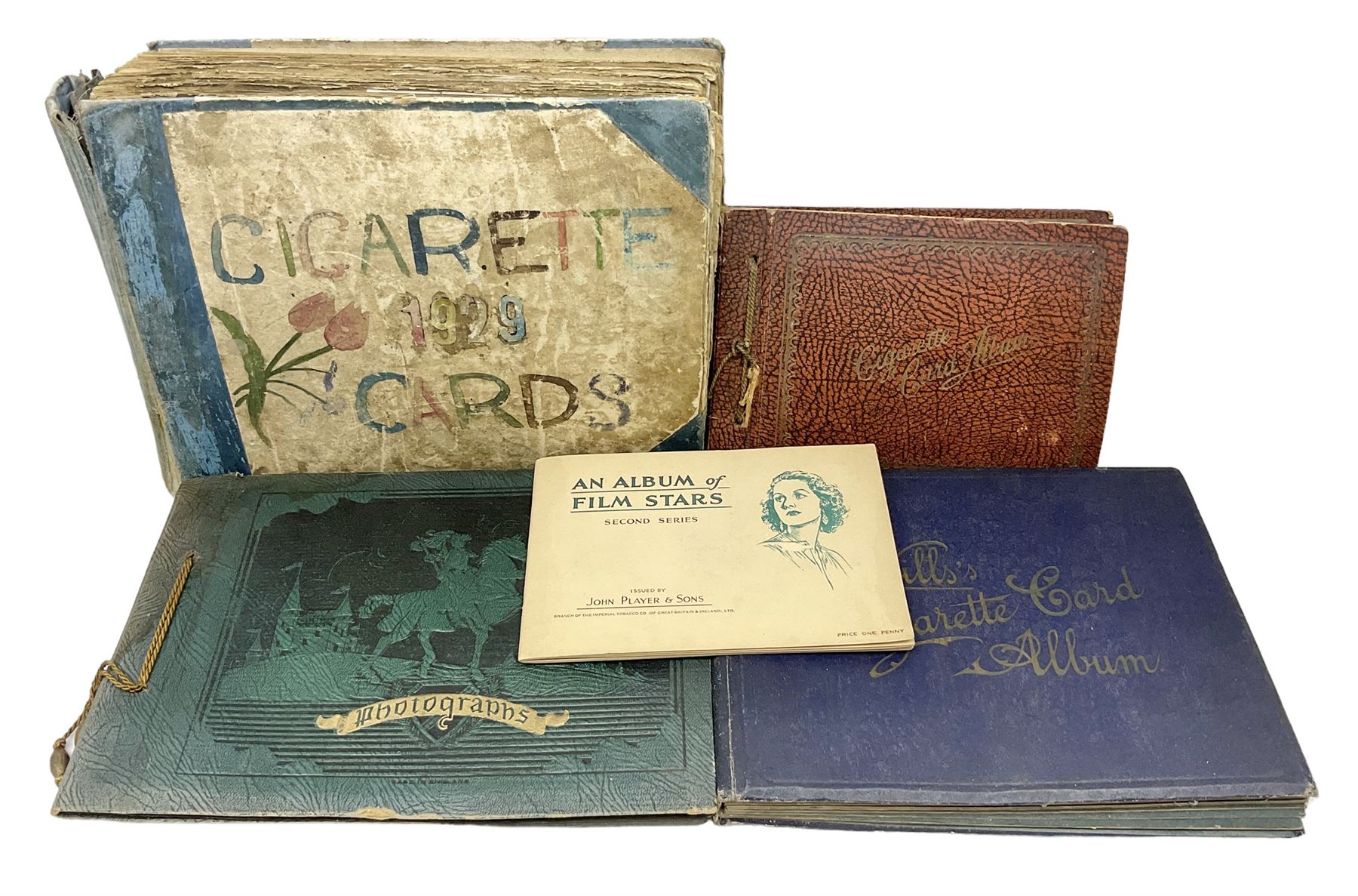 Three albums of cigarette cards including Wills Recruiting Posters, Military Motors and Allied Army Leaders, cricketers etc; another album containing a large quantity of laid-in cigarette cards; and an album of thirty-seven postcards of dogs by Mac (5)