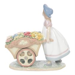 Lladro, Love's tender tokens girl, with floral filled wheelbarrow, model 6521, H23cm
