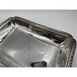 Early 20th century silver entree dish and cover, of rectangular form with shaped corners and oblique gadrooned borders to base and cover, the cover with loop 'bamboo' handle, hallmarked Thomas Bradbury & Sons Ltd, Sheffield 1930, including handle H10.5cm L24.5cm