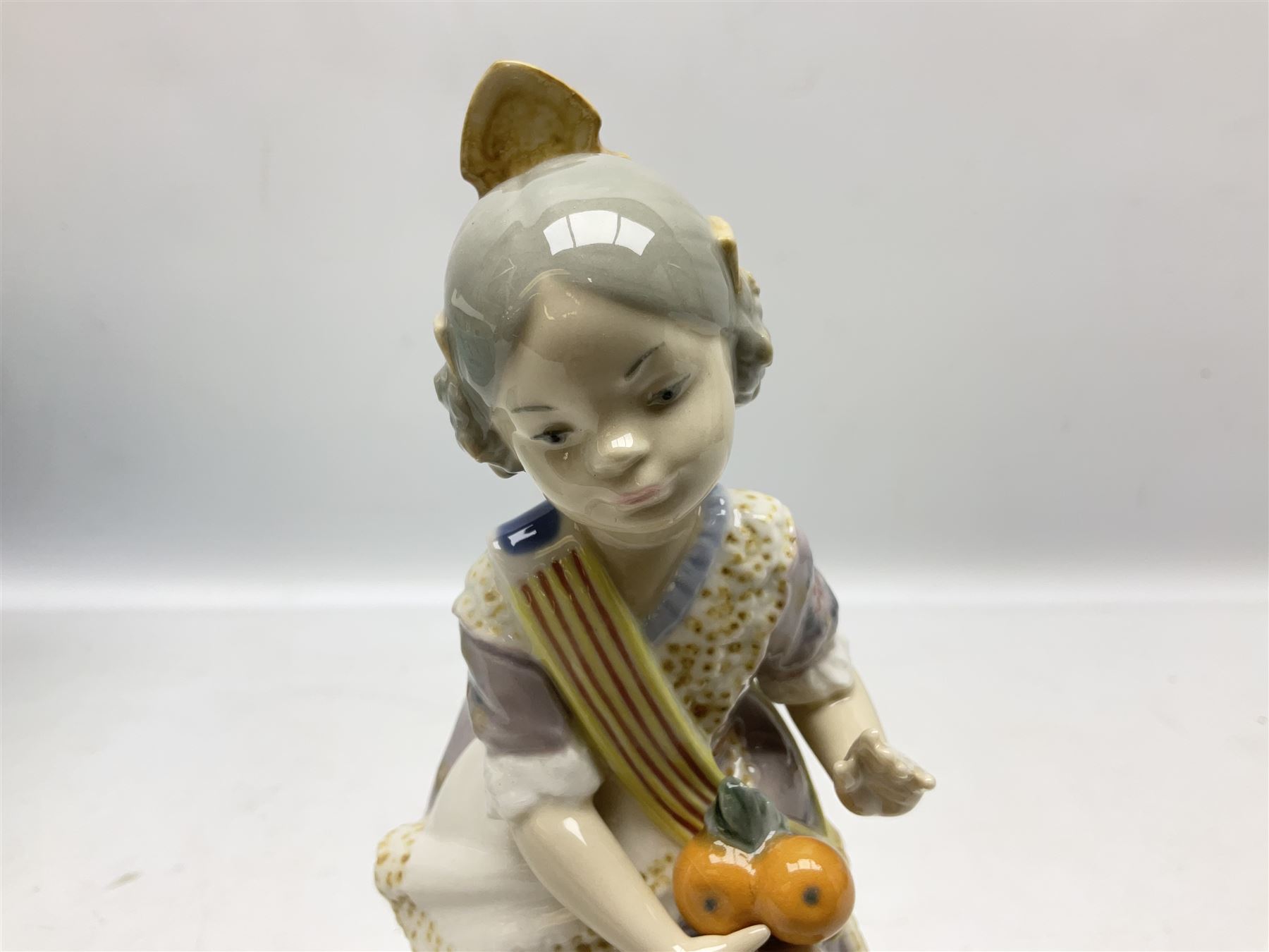 Lladro figure, Miss Valencia, modelled in traditional Valencian dress with basket of oranges, sculpted by Juan Huerta, with original box, no 1422, year issued 1982, year retired 1997, H18cm