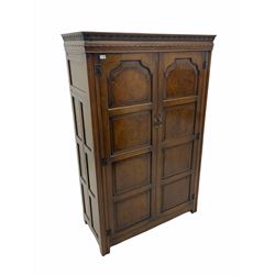 Mid 20th century figured oak double wardrobe, all-over panelling, carved cornice
