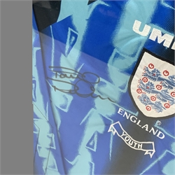 England Youth goalkeeper's shirt worn by Paul Robinson on his first international appearance for England and signed by him, mounted in a wall hanging display frame 89 x 80cm. Provenance: the vendor was a coach at Robinson's club Leeds United and was given the shirt by him.