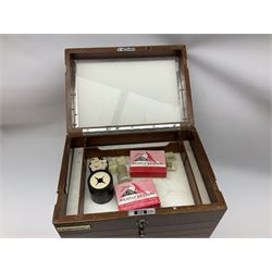 Mid 20th century portable dentist mahogany cabinet, with six glass-lined graduating drawers below a hinged lift up lid, with chrome knobs, escutcheon and carrying handle, and ivorine plaque for D. Matthews, containing a variety of tools and items relating to Dentistry, H40cm W33cm D23cm