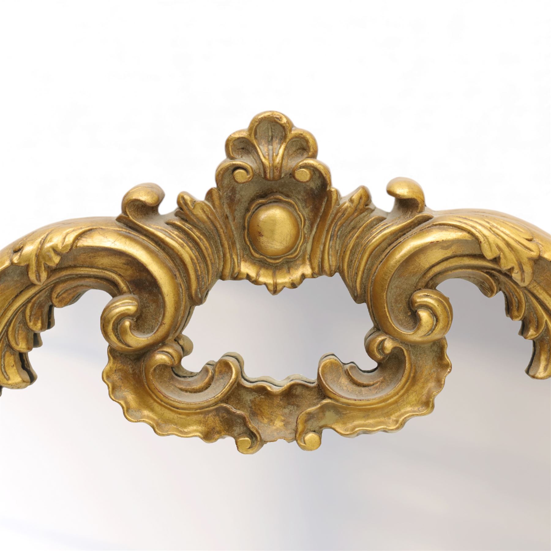 Late 20th century giltwood and composition over mantel mirror, with shaped and scrolled cresting centred by a shell cartouche, with foliate moulded shoulders and lower rail framing a rectangular plate