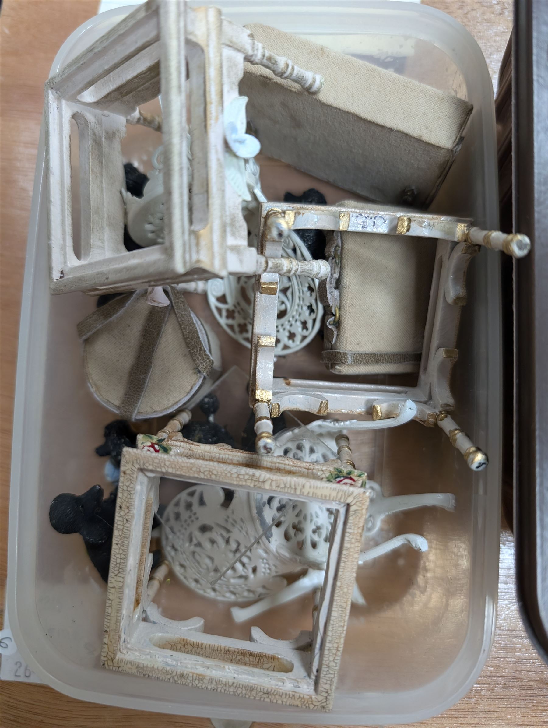 Two modern three storey dolls houses, each painted green with decorated interiors, both upon a single white wooden base, together with a large collection of dolls house furniture, accessories and figures 