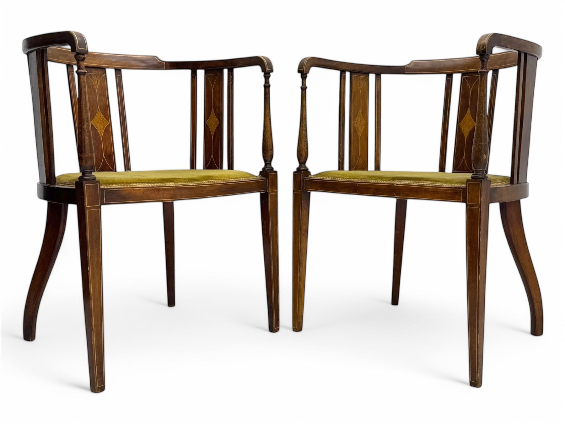 Pair of early 20th century Edwardian inlaid mahogany elbow chairs, shaped top rails with central diamond motif and line inlays, flanked by turned uprights, green velvet seats, on square tapered legs