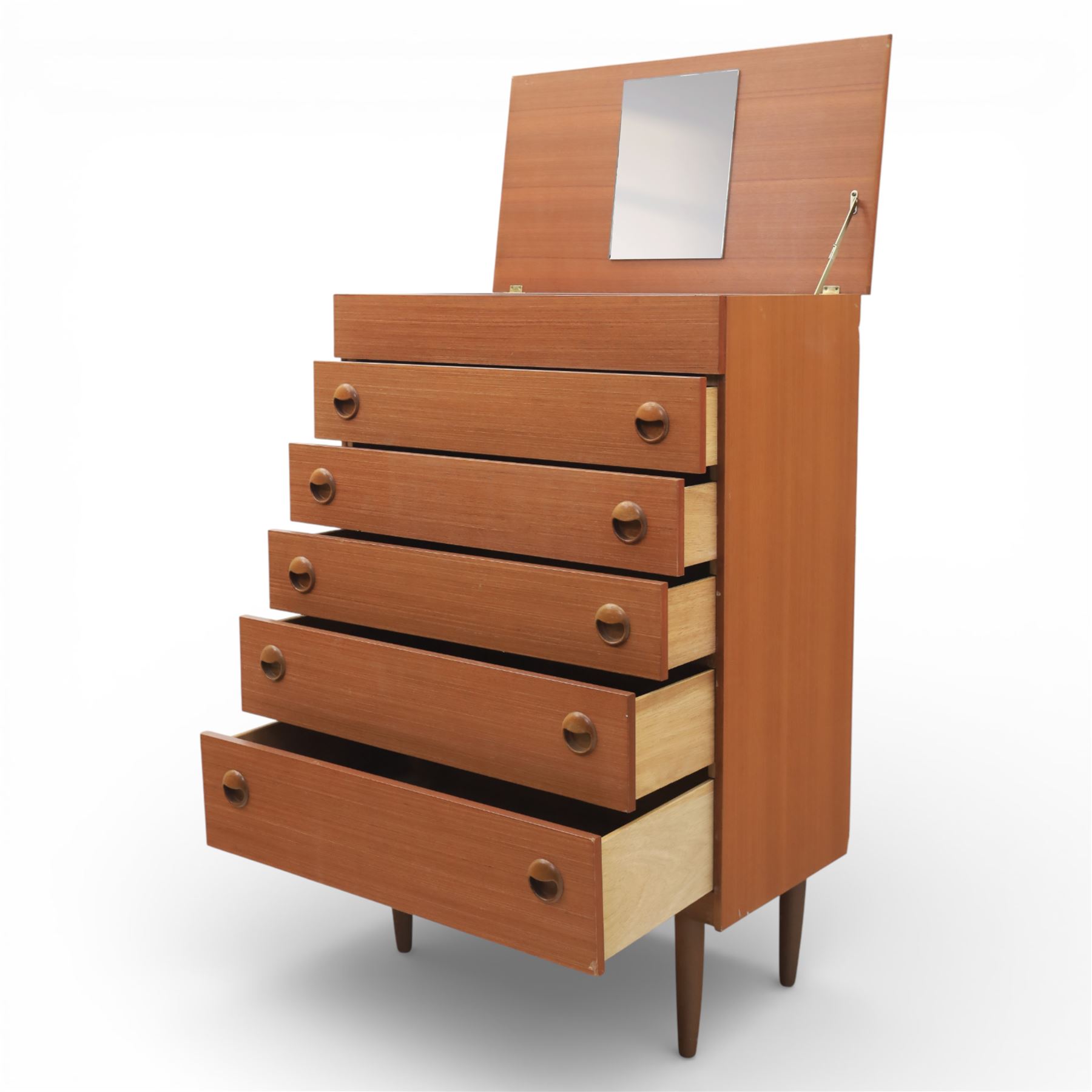 Mid 20th century teak dressing chest, rectangular top hinged to reveal a fitted interior with divisions and a rectangular mirror to the underside, over five long drawers with recessed circular handles, raised on tapering supports
