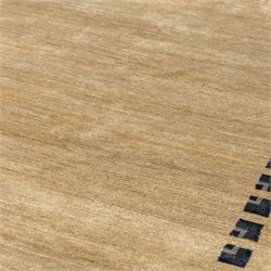 Rugs by Design - ‘Silk Stone’ Nepalese thick pile wool rug, with plain textured camel ground and geometric border detail in blue, grey and dark tones to two sides