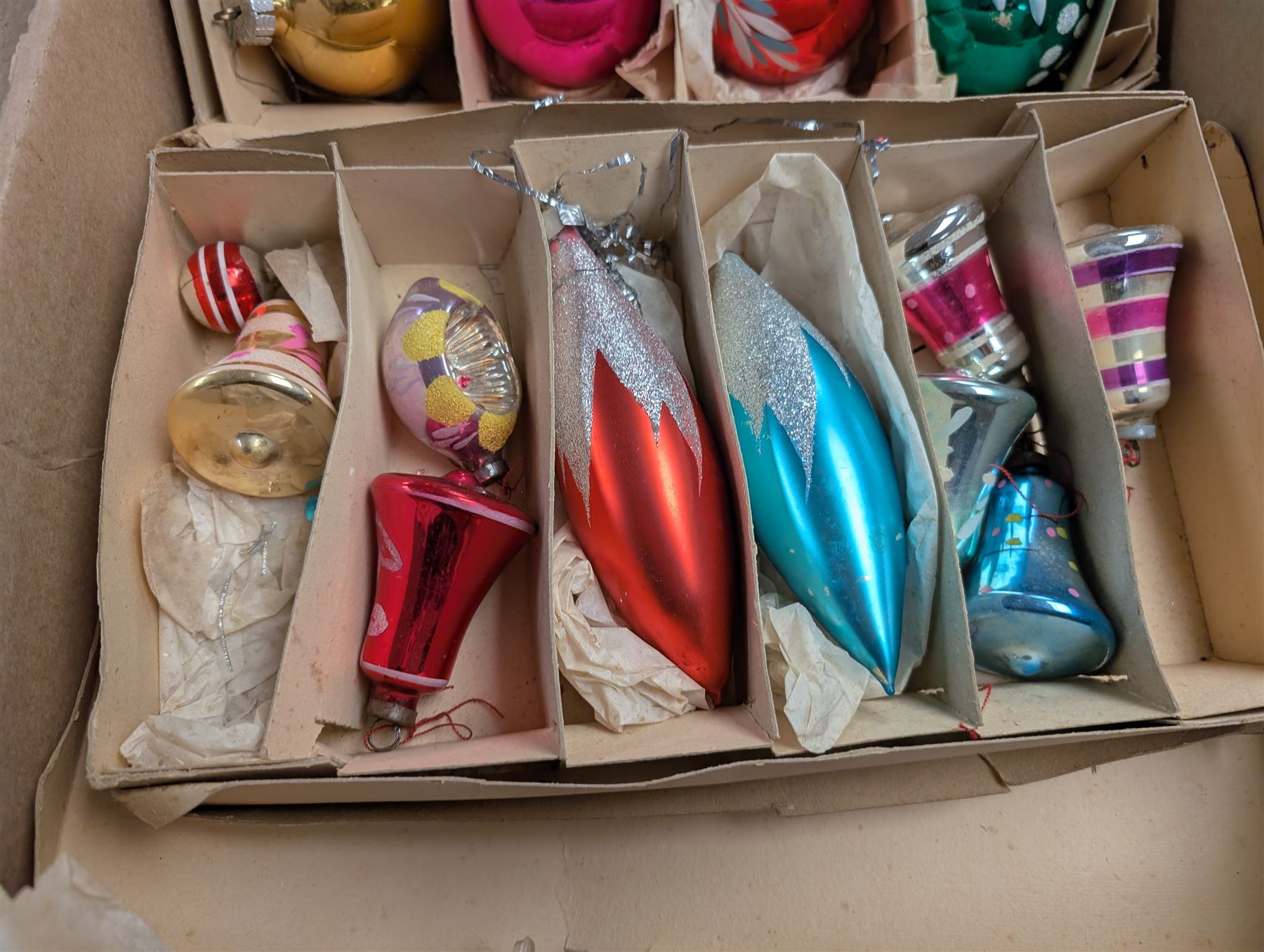 Collection of colourful vintage Christmas decorations, including glass and metal baubles