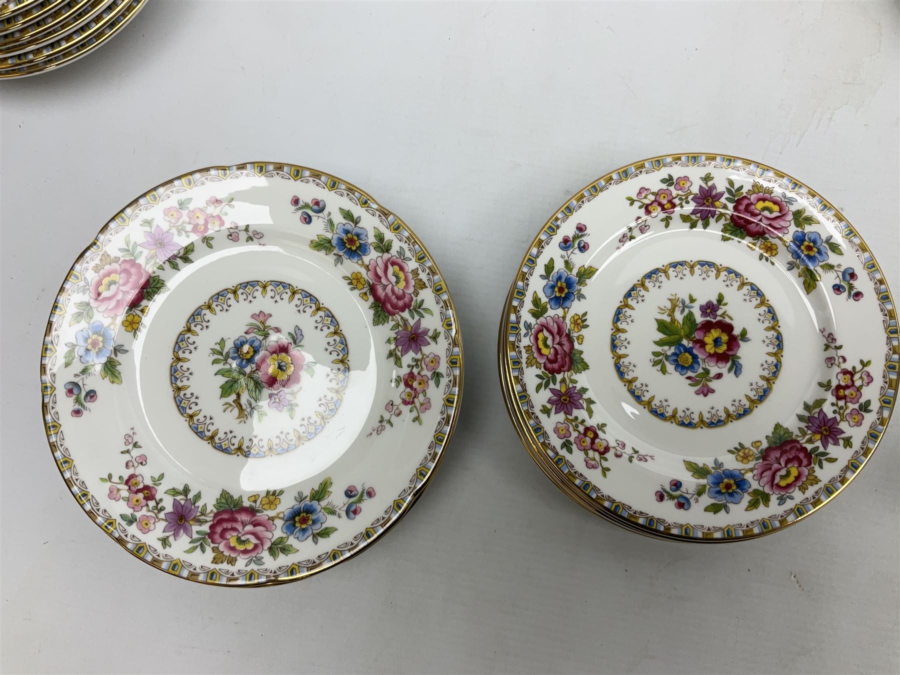 Extensive Royal Grafton Malvern pattern tea and dinner wares, comprising twelve dinner plates, six smaller plates, coffee pot, two teapots, two cake plates, eight teacups and ten saucers, six coffee cups and six saucers, two open sucriers, twin handled lidded sucrier, jug, lidded mustard pot and condiment jar, lidded tureen, two circular twin handled vegetable tureens, sauce boat and stand, oval and circular serving plates, salt and pepper shakers, breakfast cup and two saucers, further large cup and saucer, eighteen tea plates of various shapes, six side plates, six cereal bowls and six further bowls, shell dish and dish of square form, fork and knife, together with a hallmarked silver condiment spoon