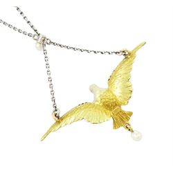 Early 20th century platinum and gold enamel, pearl and diamond dove pendant necklace, the dove in flight, with applied opalescent enamel, ruby set eyes and the wings outlined with rose cut diamonds, its claws holding a round cut ruby and suspending a pearl drop, stamped 18ct, to a platinum chain set with an additional pearl