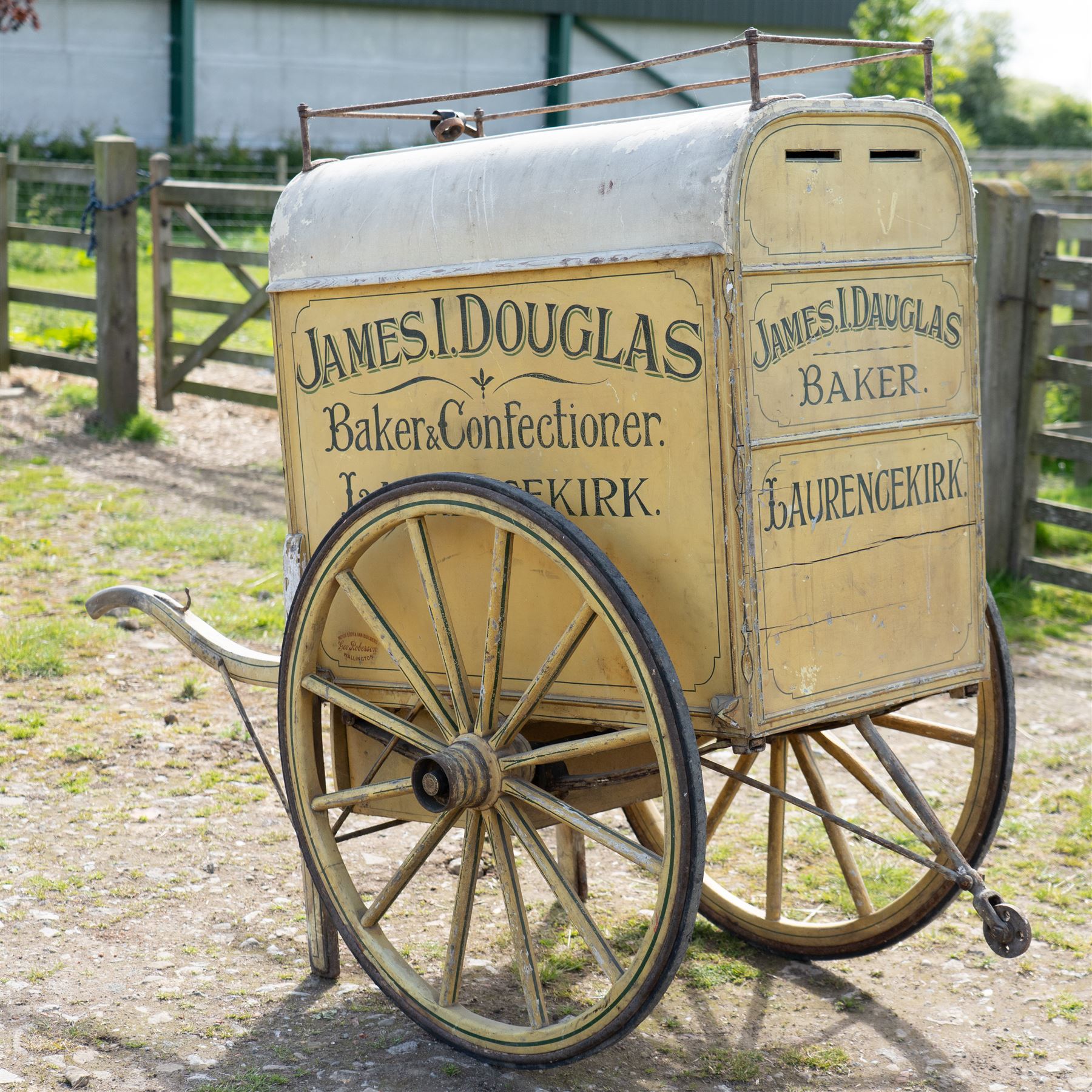 James I. Douglas, Baker & Confectioner, Laurencekirk Hand Drawn Delivery Cart

An attractive late 19th or early 20th century hand drawn baker's delivery cart, finished in cream and retaining its original hand painted advertising livery for James I. Douglas, Baker & Confectioner, Laurencekirk. The enclosed body features a curved roof with external luggage rail, rear access doors and internal shelving for the transport and delivery of bread, cakes and confectionery. Mounted on large wooden spoked wheels with iron tyres and fitted with shaped shafts for a single horse, this is a highly decorative and increasingly scarce example of a provincial tradesman's delivery vehicle, offering excellent display potential for collectors, museums, period interiors or commercial settings.

Features:
• Original hand painted signwriting for James I. Douglas, Baker & Confectioner, Laurencekirk
• Enclosed delivery body with curved roof and external luggage rail
• Rear opening access doors with internal storage compartments
• Original internal wooden shelving and racks
• Large wooden spoked wheels with iron tyres
• Shaped shafts for single horse traction
• Builder's mark for Geo. Roberson Ltd., Wallington
• Decorative cream painted finish with period lining and detailing
• Suitable as a display piece, museum exhibit or advertising feature

Dimensions:
Overall length: 170 cm
Body length: 104 cm
Width: 83 cm
Height: 150 cm

Wheel Diameter:
Wheels: 95 cm