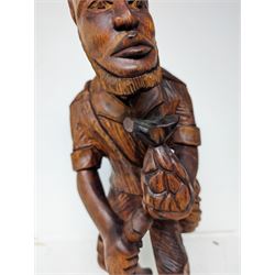 African carved wooden figure, modelled as a man holding a pineapple, H63cm
