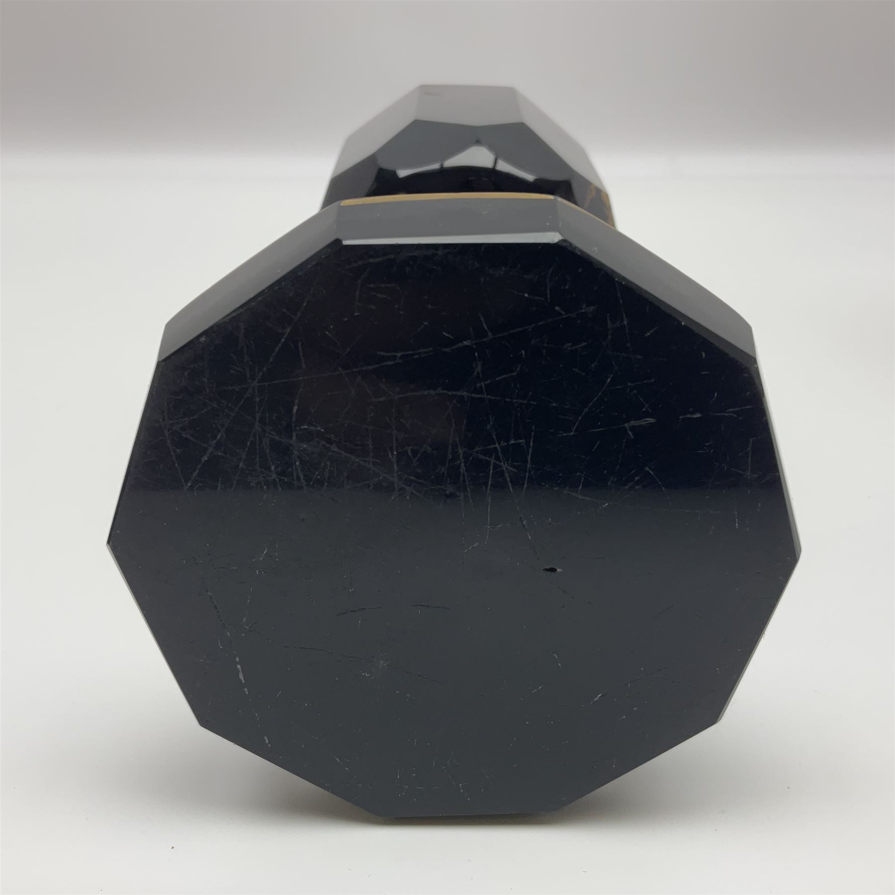 19th Century Bohemian amethyst glass lidded goblet, the bowl of faceted form, gilded with three children in period dress playing games, upon a knopped stem and conforming faceted foot, together with an art nouveau green glass goblet, with gilded rim, upon clear trumpet stem, and a hand blown wine glass, transfer printed with birds and three figures in period dress, tallest H29cm