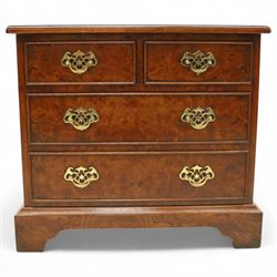 Late 20th century figured walnut miniature chest, the rectangular top with feather banded border over two short and two long drawers, fitted with brass batwing handles, upon moulded plinth base and four bracket feet, H60cm, w67cm, D36cm