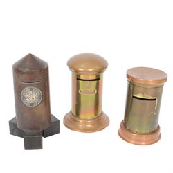 Early 20th century moneyboxes, including trench art example, Bakelite example with applied West Africa Two Shilling coin engraved 'Joan', three brass pot boxes and a wooden ebonised example with brass mounts, tallest H15cm