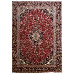 Central Persian Kashan hand-knotted carpet, crimson ground field, with central cusped loze...