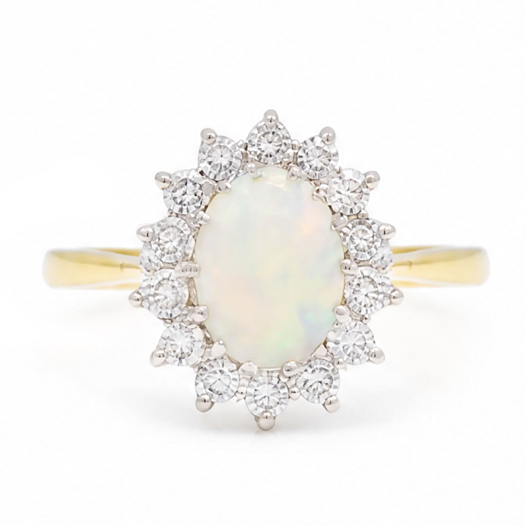 18ct gold opal and diamond cluster ring, single oval cabochon cut opal, surrounded by fourteen round brilliant cut diamonds, London 1988, total diamond weight approx 0.30 carat