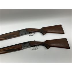 Two Russian Baikal 12-bore over-and-under double barrel boxlock non-ejector sporting guns; one with 68.5cm barrels, walnut stock with chequered pistol grip and fore-end and thumb safety, serial no.520545, L111cm overall; the other with 72.5cm barrels, walnut stock with chequered pistol grip and fore-end and thumb safety, serial no.012448, L114.5cm overall (2) SHOTGUN CERTIFICATE REQUIRED