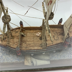 Stamp montage model of the galleon Ark Royal by Mr. G.R. Inch of Scarborough L24cm H23cm with stand on simulated sea base in glazed display cabinet with associated newspaper cuttings dated 1963