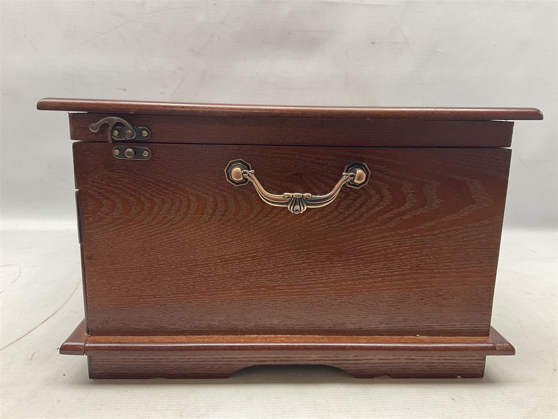 Waltmann und Sohn part canteen of stainless steel and gilt cutlery, the stained wood case with hinged lid above two fitted drawers, L48cm