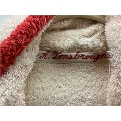 On the direct instructions of Anita Porter nee Lonsbrough Great British Olympic and Commonwealth Games gold medal winning swimmer - collection of early and international memorabilia comprising original Huddersfield Bath Club track suit top bearing eight stitched on cloth badges including British Empire & Commonwealth Games 1958 England Team, YSASA, North Eastern Counties ASA, ESSA Division 3,  English Schools Swimming Association winner etc
The swimming costume Anita wore at the 1958 Commonwealth Games in Cardiff, her first major championships, where she won two gold medals. The grey elastic on the sides, in those days, she would use to make it tighter and more streamlined.
Blue track suit from the 1960 Olympics which she wore on the podium receiving the gold medal.
1960 pool side towelling robe used at the Rome Olympics (interesting to note her name is spelt wrong on the embroidered label).
1962 Commonwealth Games pool side towelling robe used in Perth Australia when winning three Gold medals. 
It was also this year she became BBC Sports Personality of the year, the first female to do so.
Her 'lucky' pool side towel which she took with her to every event she competed in and which can be seen round her neck in many official celebratory photographs. Copies of some of these photographs are included for identification.
In addition there are two souvenir programmes of an evening event to honour Anita at The Theatre Royal Huddersfield and she has kindly signed the front cover on one of these.