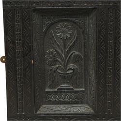 Victorian heavily carved oak wall mirror, lunette and foliage carved frieze over central bevelled mirror and flanking panels carved with floral urns, the upright frame decorated with geometric pattern chip carvings, lunette carved lower rail 