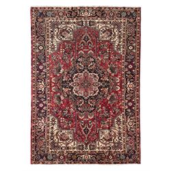 Persian Heriz red ground rug, large medallion decorated with palmettes and Ejder motifs, the border decorated with stylised plant motifs, within floral design guard stripes 