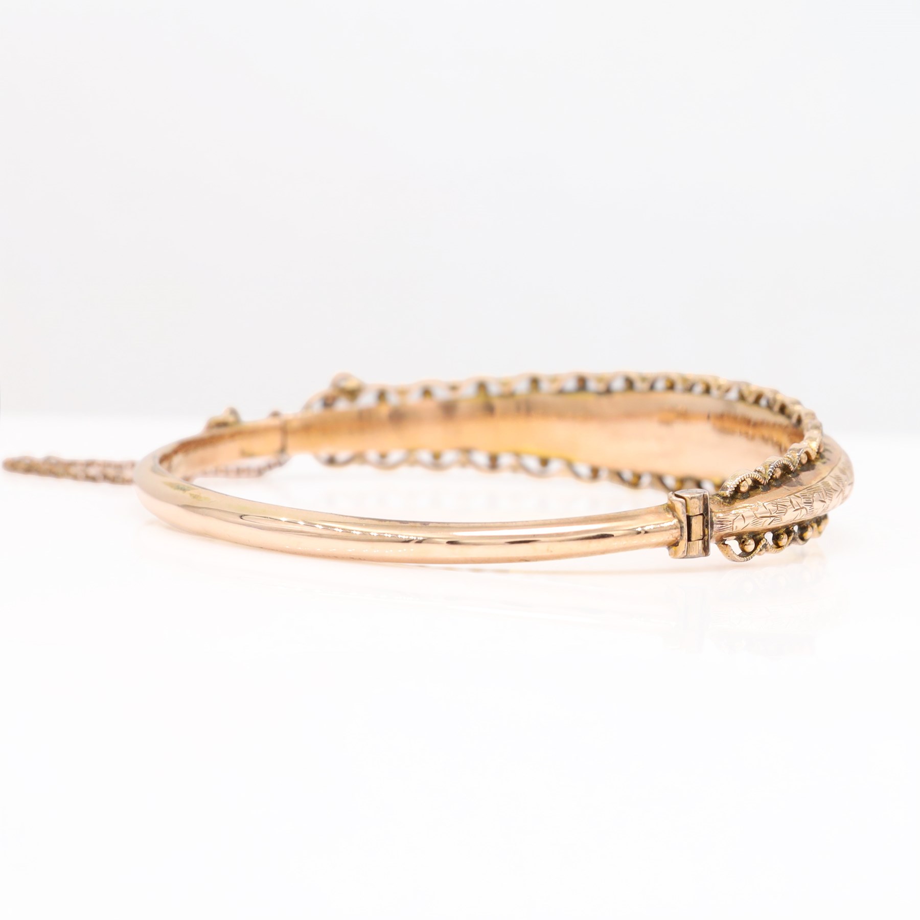 Edwardian 9ct rose gold bangle, with engraved decoration and wirework and bead work surround, Chester 1904