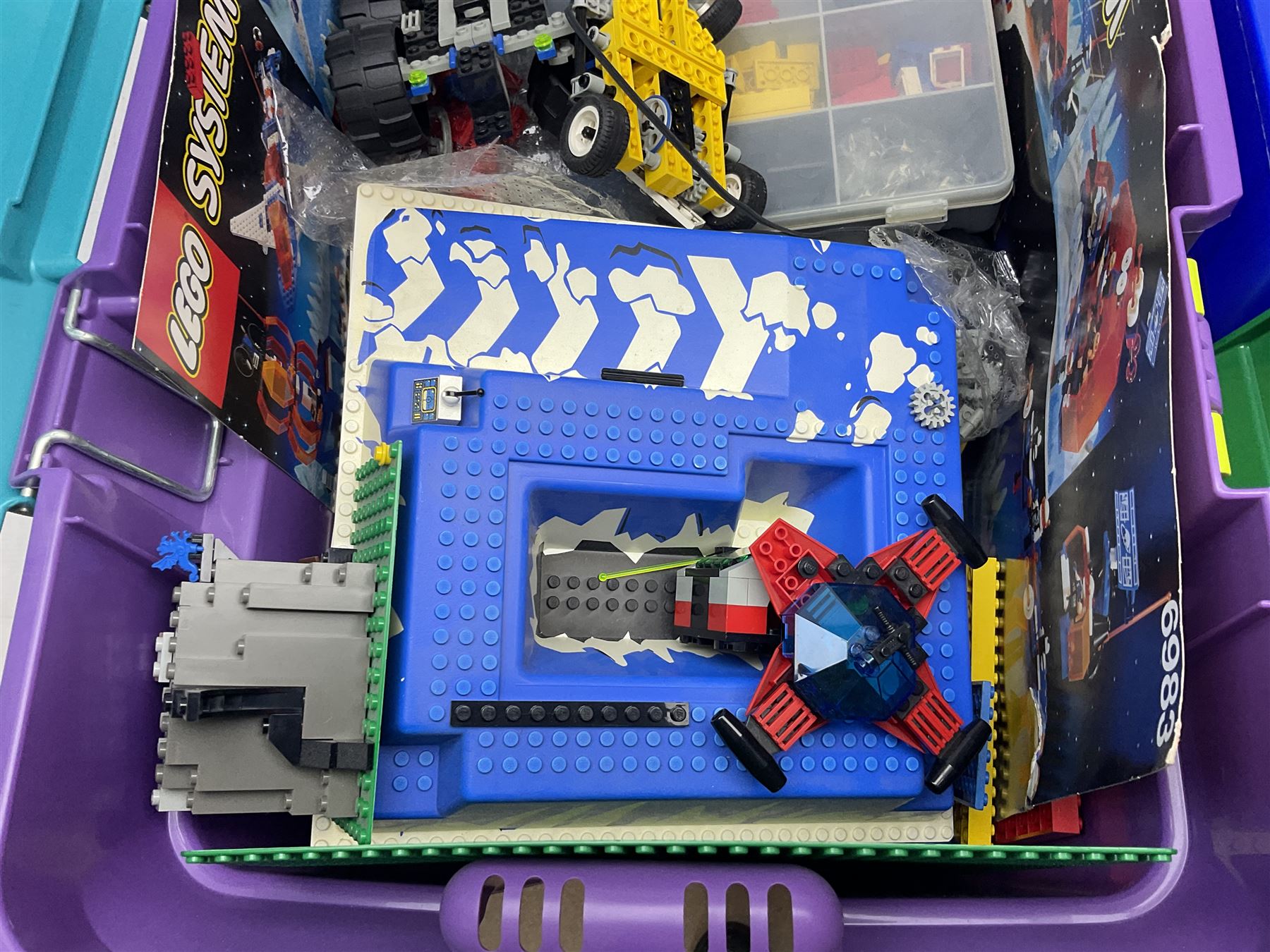 Lego - large quantity of part-built models and loose component parts including Lego Technic and Lego System, space and road vehicles, ships and boats, helicopter etc; together with two set boxes and folder  containing large quantity of instruction booklets; stored in two very large plastic boxes