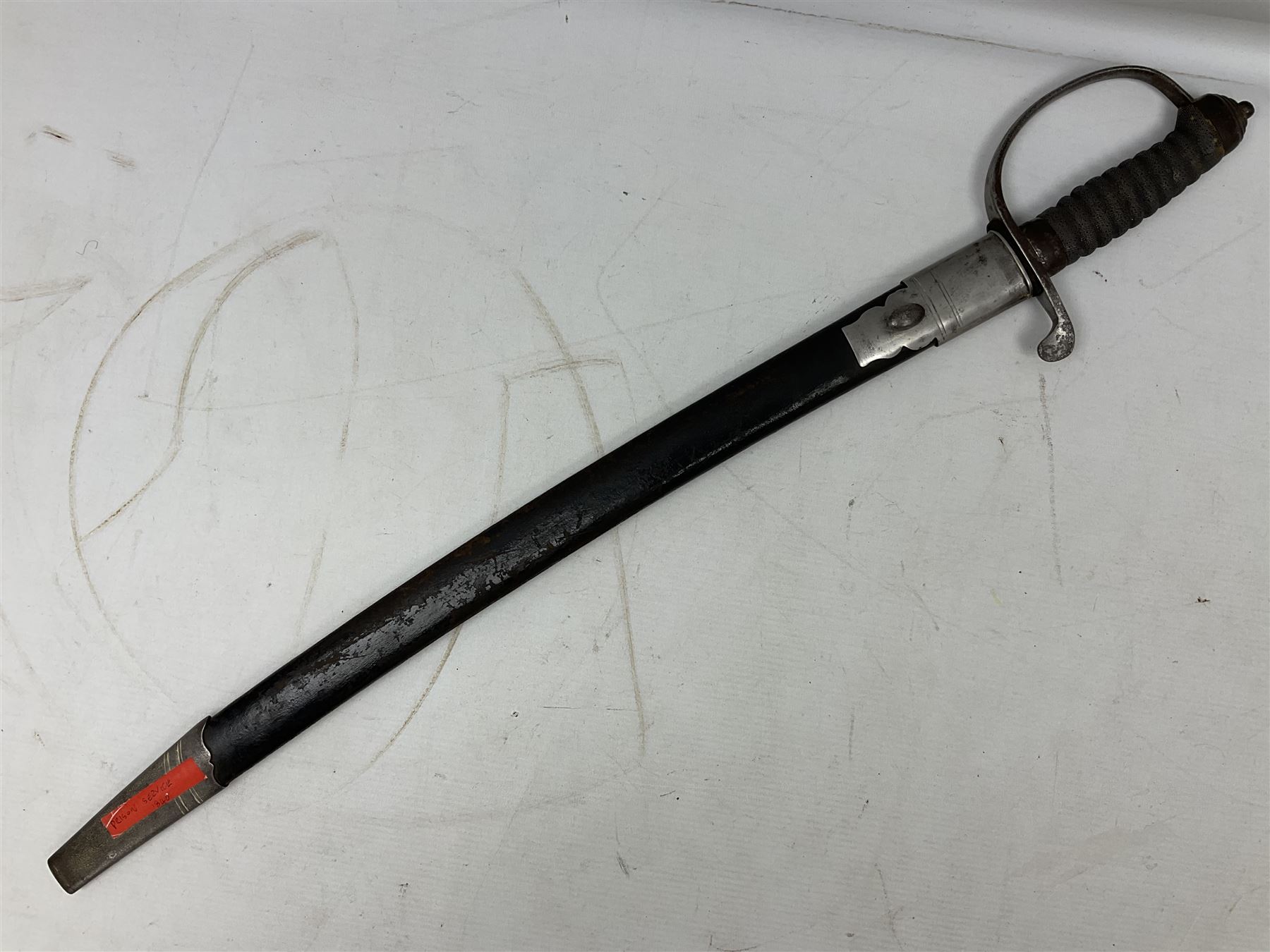 Mid-19th century Custom’s officer/Constabulary sidearm, with plain 60.5cm slightly curving fullered blade double edged at tip,  steel knucklebow and downswept quillon, stepped pommel and ribbed fishskin grip; in leather covered scabbard with steel locket, frog stud and chape L76cm overall