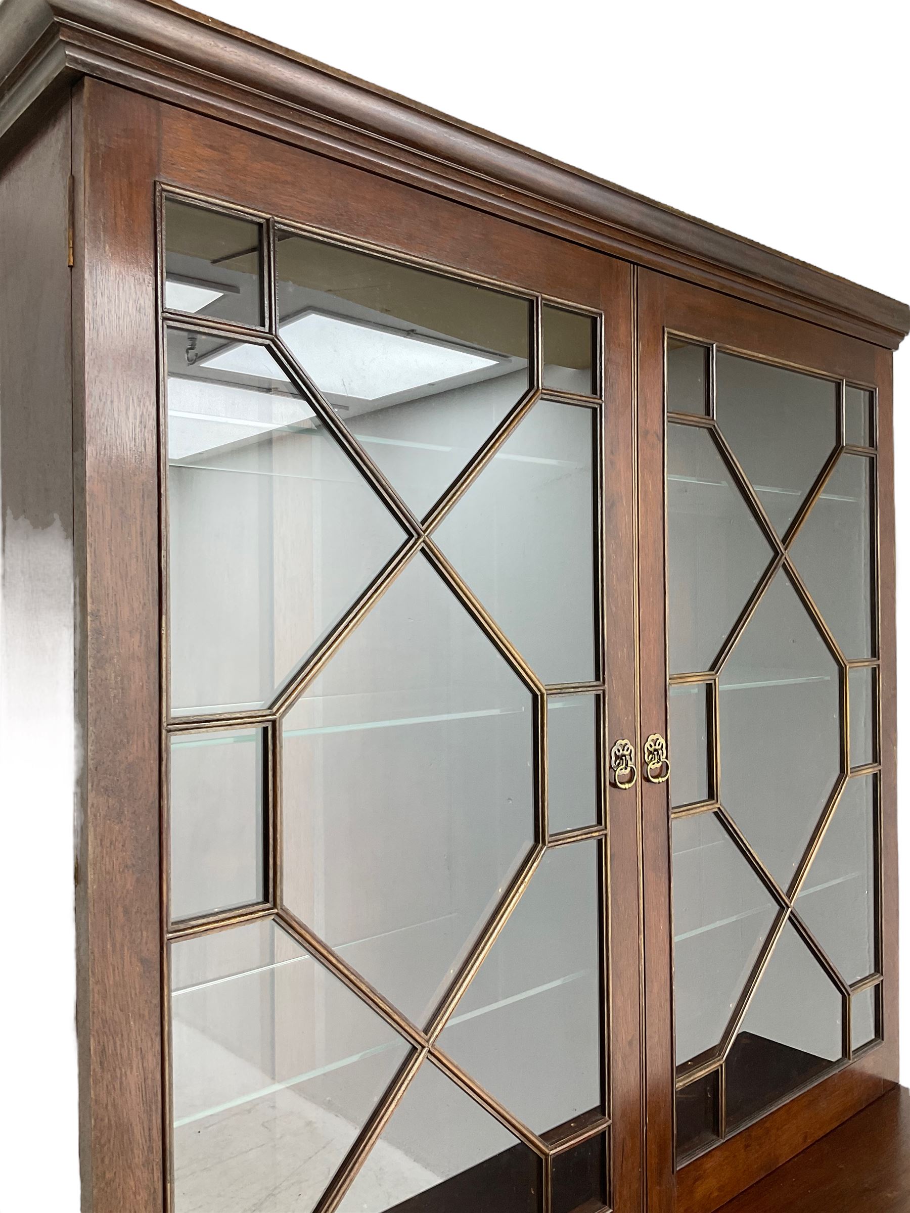 Acorn Industries - Georgian design mahogany bookcase on cupboard, fitted with two astragal glazed doors enclosing three glass shelves, base with two cock-beaded drawers over two panelled cupboards, inlaid with acorn signature, by Alan Grainger, Brandsby