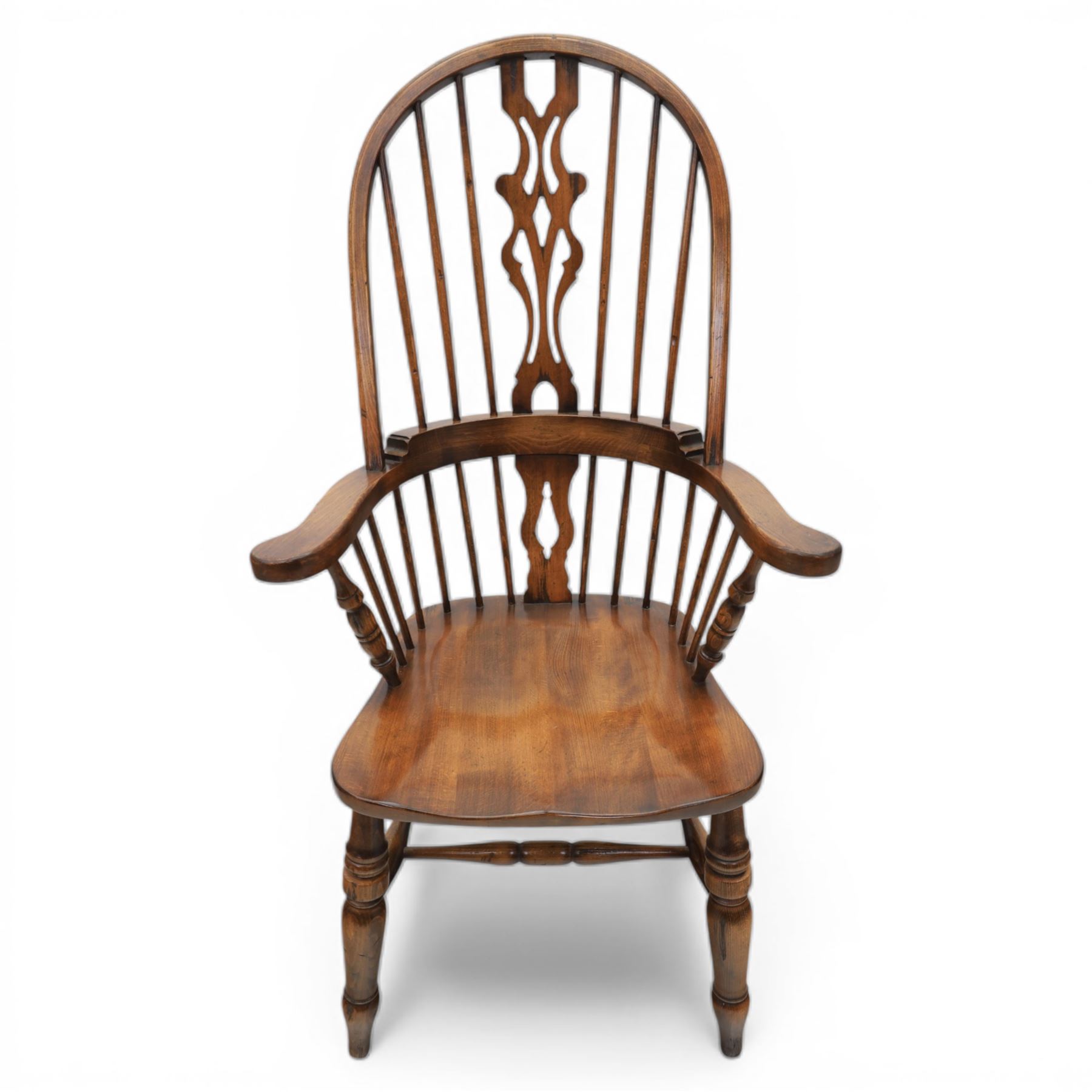 Late 20th century elm and beech high back Windsor armchair, the arched hoop back with pierced vase shaped splat between turned spindles, shaped arm rail on turned supports, saddle seat, raised on turned legs united by a crinoline stretcher