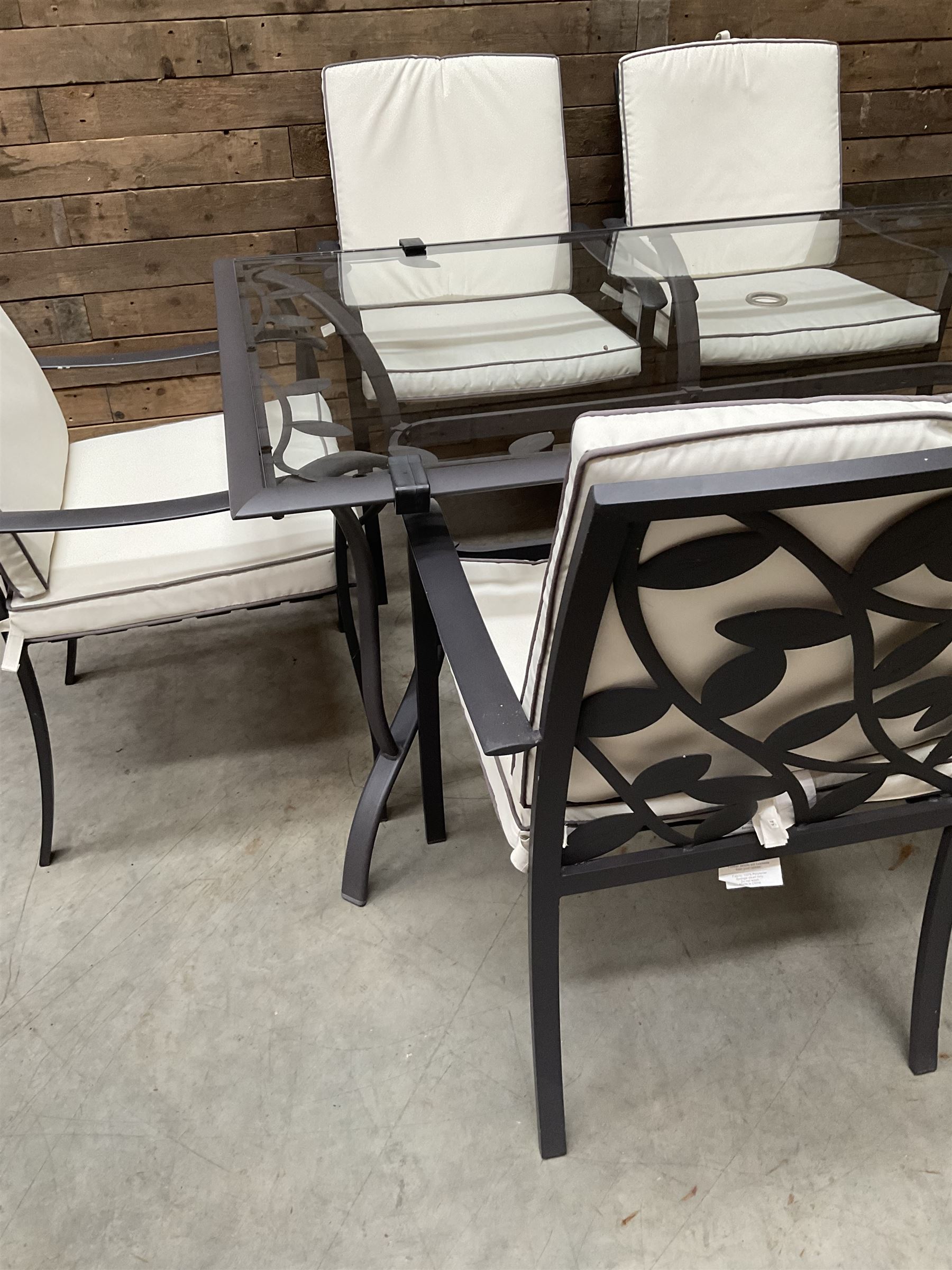 Metal framed garden table with glazed top (W170cm, D102cm, H71cm) and six armchairs with cushions 