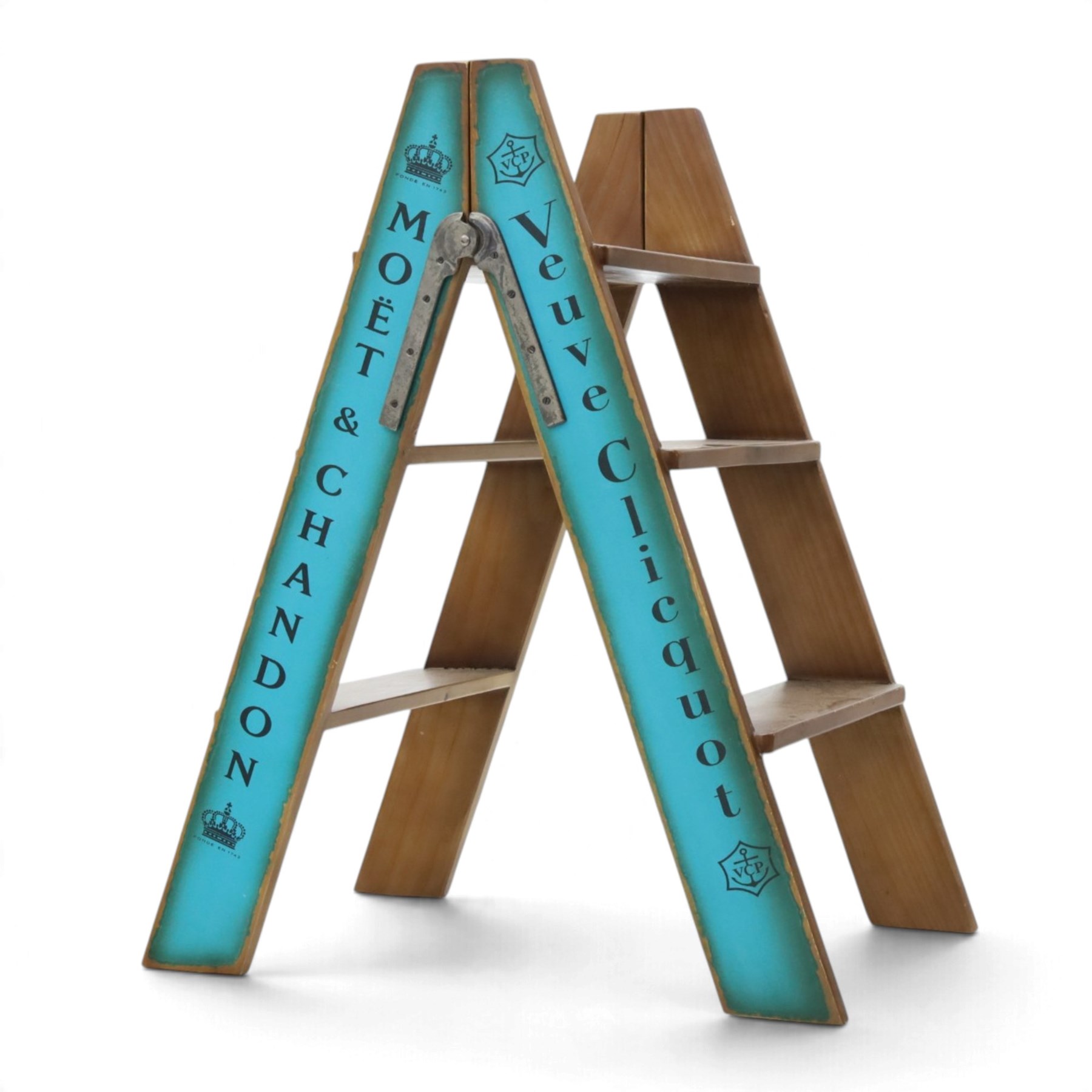 Contemporary wooden folding stepladder, three treads to each side, turquoise painted panels bearing champagne logos, with metal hinges and folding stays