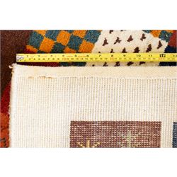Persian style Gabbeh Loribaft design ivory ground rug, the vibrant field decorated with geometric patchwork design panels with interspersed stylised tree motifs, enclosed by a wide ivory guard band