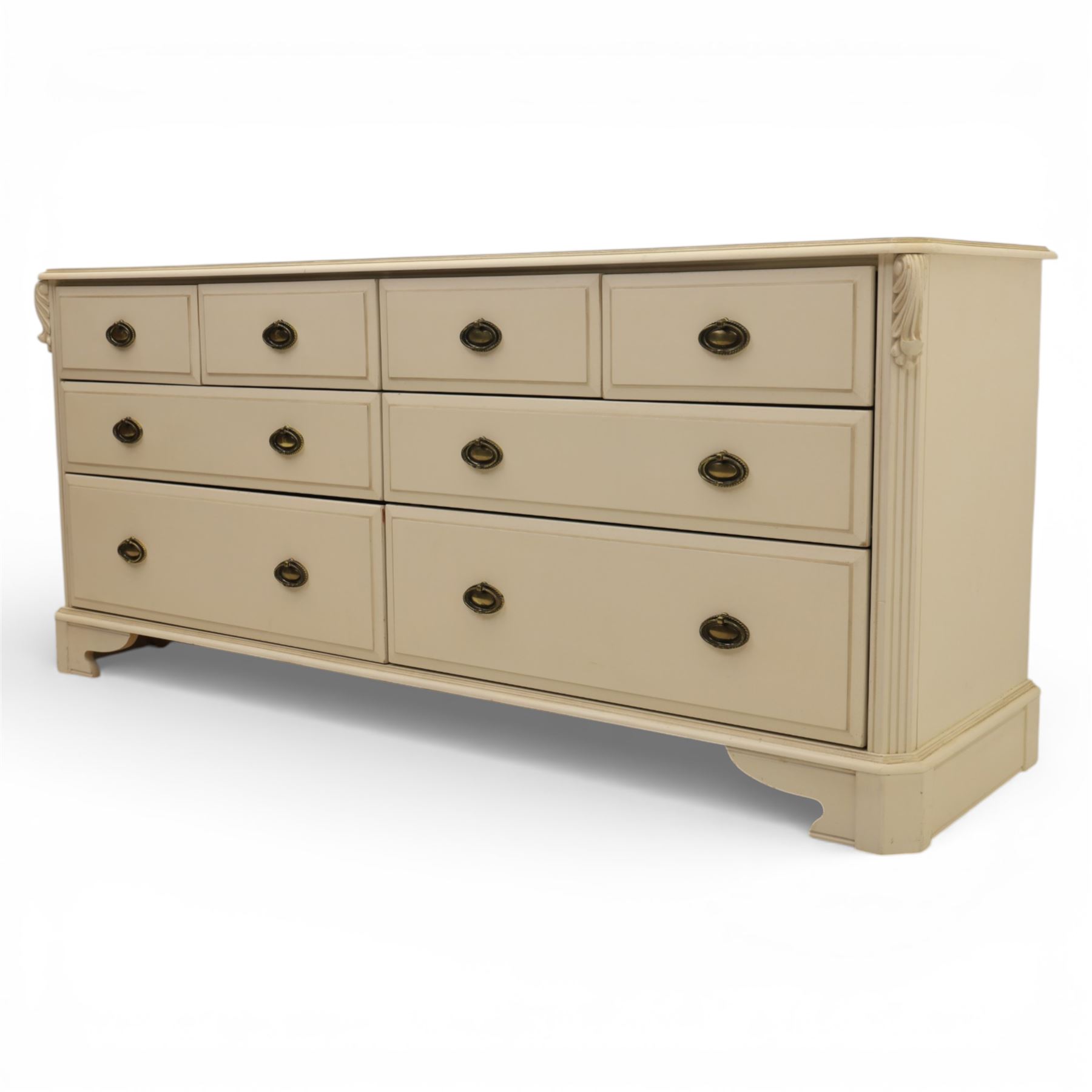 Contemporary French design white painted bedroom suite retailed by Barkers of Northallerton, comprising wide chest fitted with four short and four long drawers with oval brass handles (H 70cm, W 159cm, D 46cm), pair of bedside chests each fitted with three drawers (H 62cm, W 40cm, D 46cm), dressing table fitted with four short drawers and central kneehole with shaped apron (H 79cm, W 131cm, D 46cm) with matching framed wall mounted mirror (H 100cm, W 113cm), and full length standing mirror (H 175cm, W 73cm)