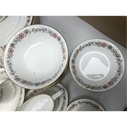 Royal Albert Paragon tea and dinner service for twelve decorated in the Belinda pattern, comprising fourteen saucers, twelve teacups, thirteen side plates, teapot, sauce boat and stand, salt and pepper shakers, two jugs, sucrier, twelve dinner plates, twelve smaller plates, two lidded tureens, twelve bowls, twelve smaller bowls, cake plate, oval plate and oval dish (100)