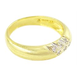 Gold diamond ring, rubover set with nine round brilliant cut diamonds