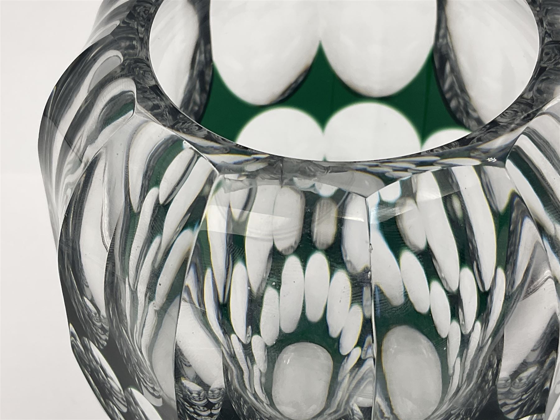 Val St Lambert style glass vase of shouldered ovoid form, cased in deep green over clear and heavily cut with repeat spherical pattern, indistinctly signed beneath ('Jac E. Dalmley'?), H15cm